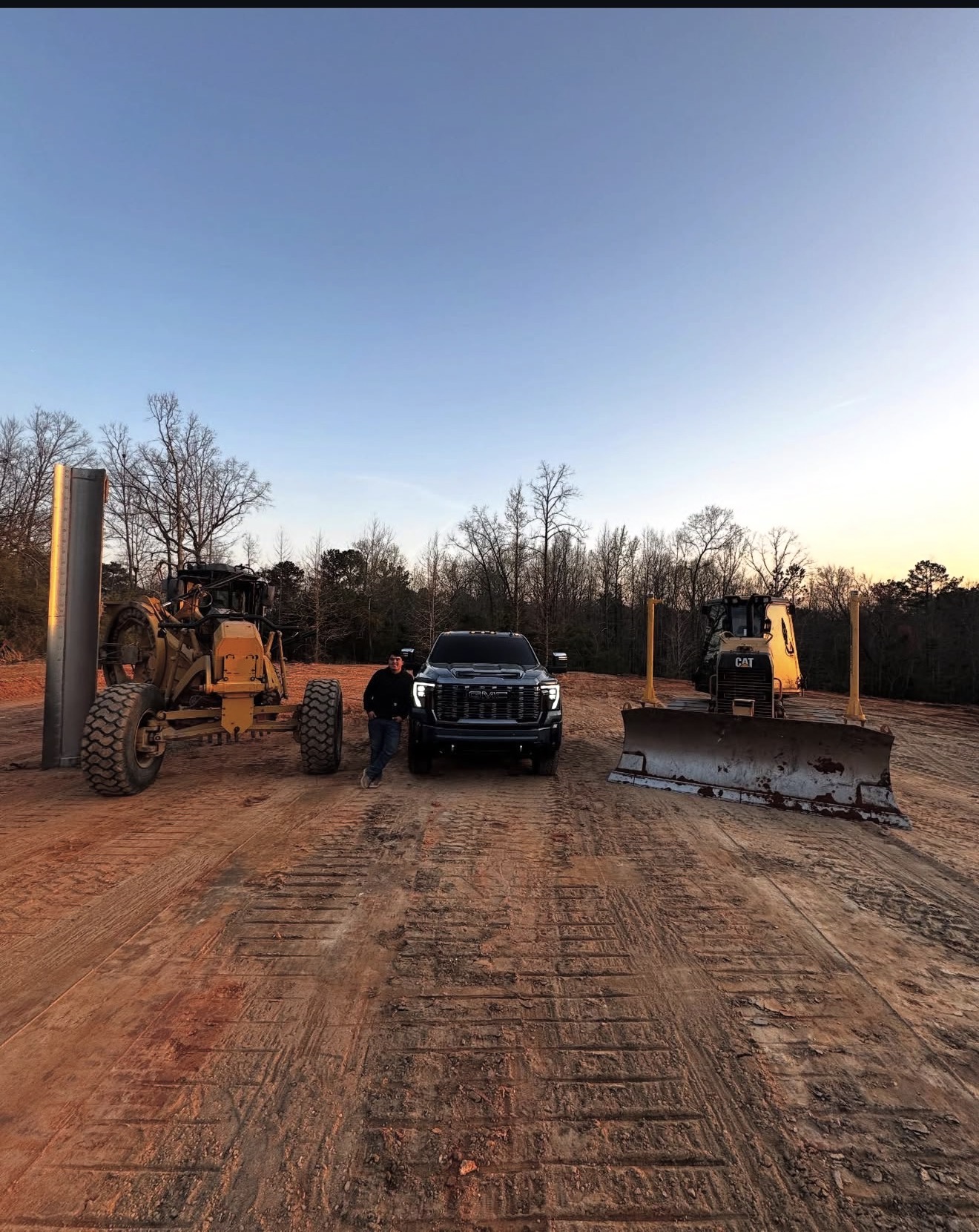 Allen Zuniga, owner of Pine Valley Clearing and Grading, with work truck and grading equipment